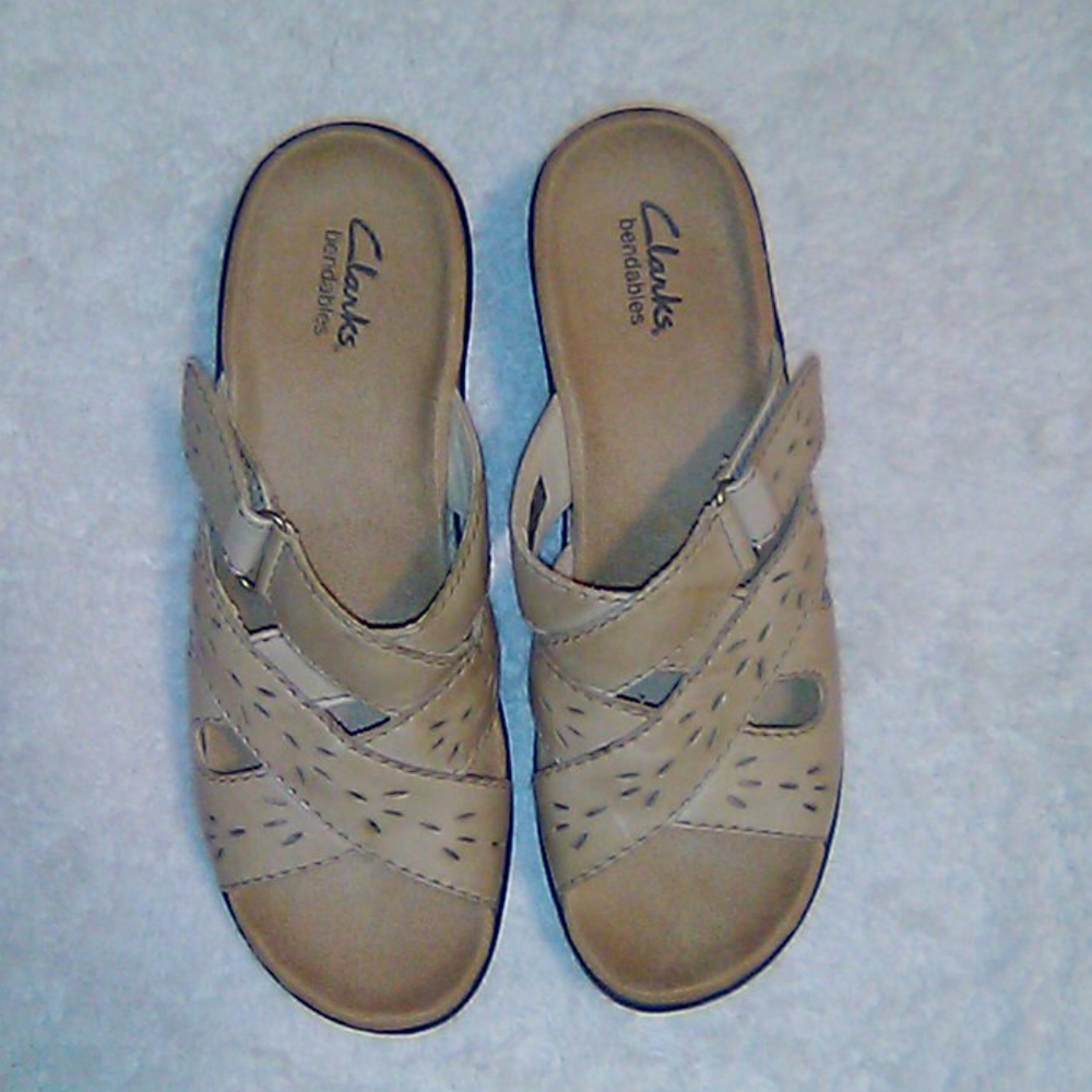 Clark's Nude colored slip on sandals.